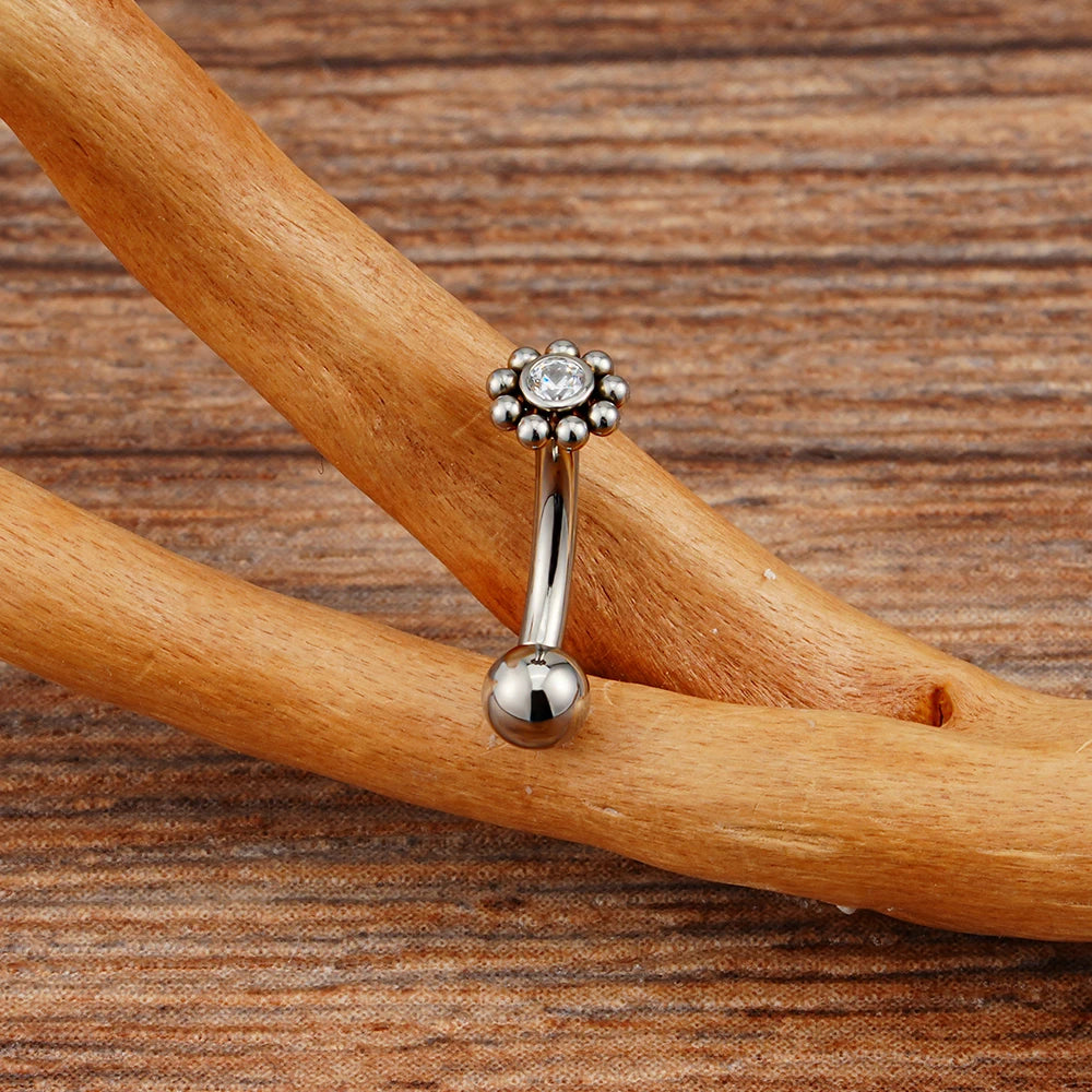 Anti-tragus ear piercing with a clear cz stone and dots in a flower shape short curved barbell