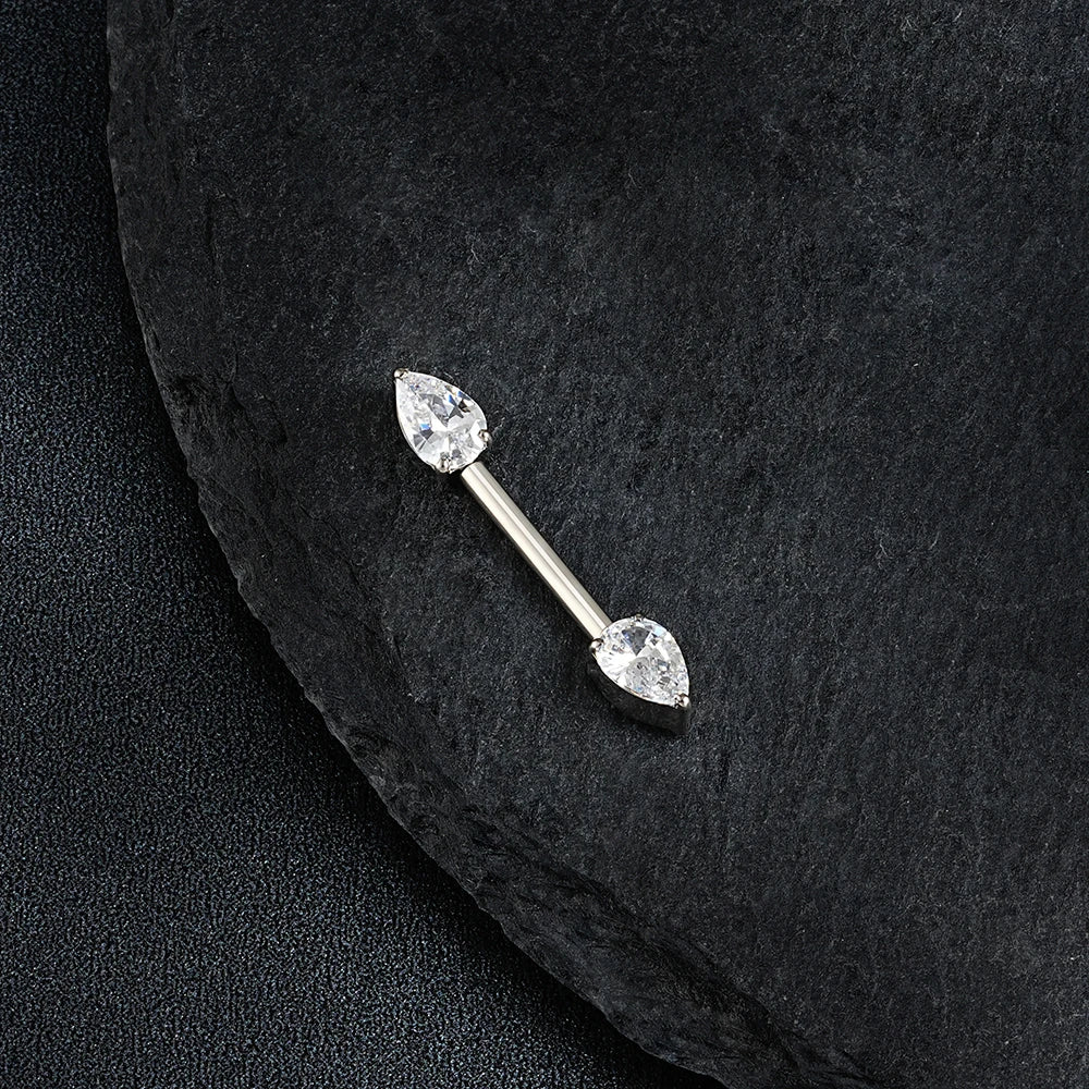 Silver barbell with teardrop-shaped crystals on a black stone background