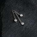 Chain charm for ear piercings with three clear stones and three chains