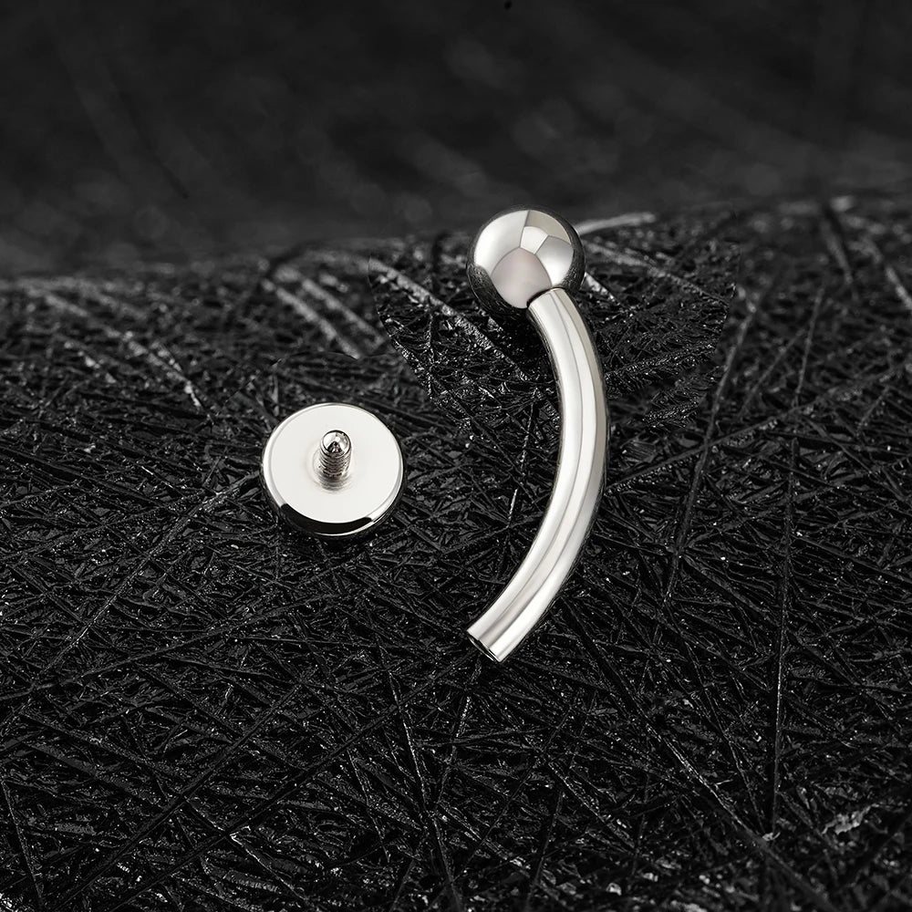 Rhino nose piercing with a flat disc a flat top titanium curved barbell