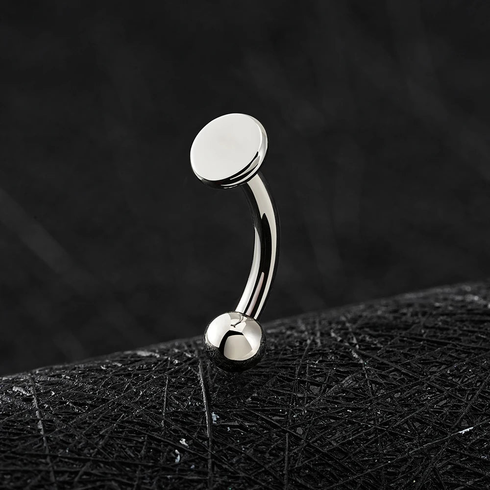 Rhino nose piercing with a flat disc a flat top titanium curved barbell