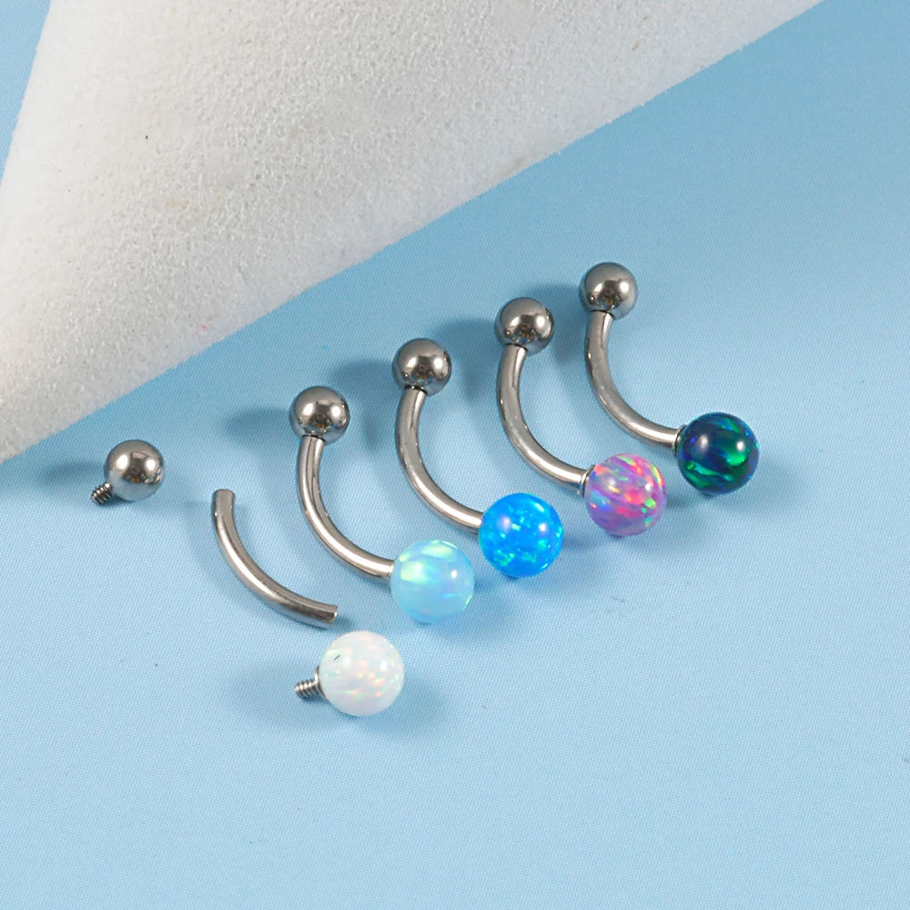 Barbell eyebrow piercing with opal titanium curved barbell