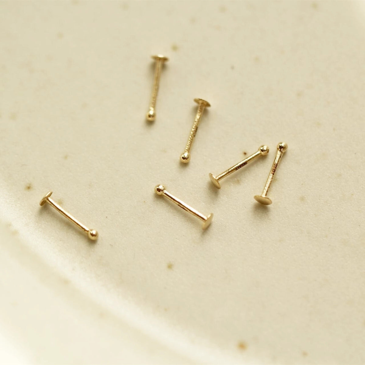 Nose bone stud 14K gold tiny and minimalist Rosery Poetry